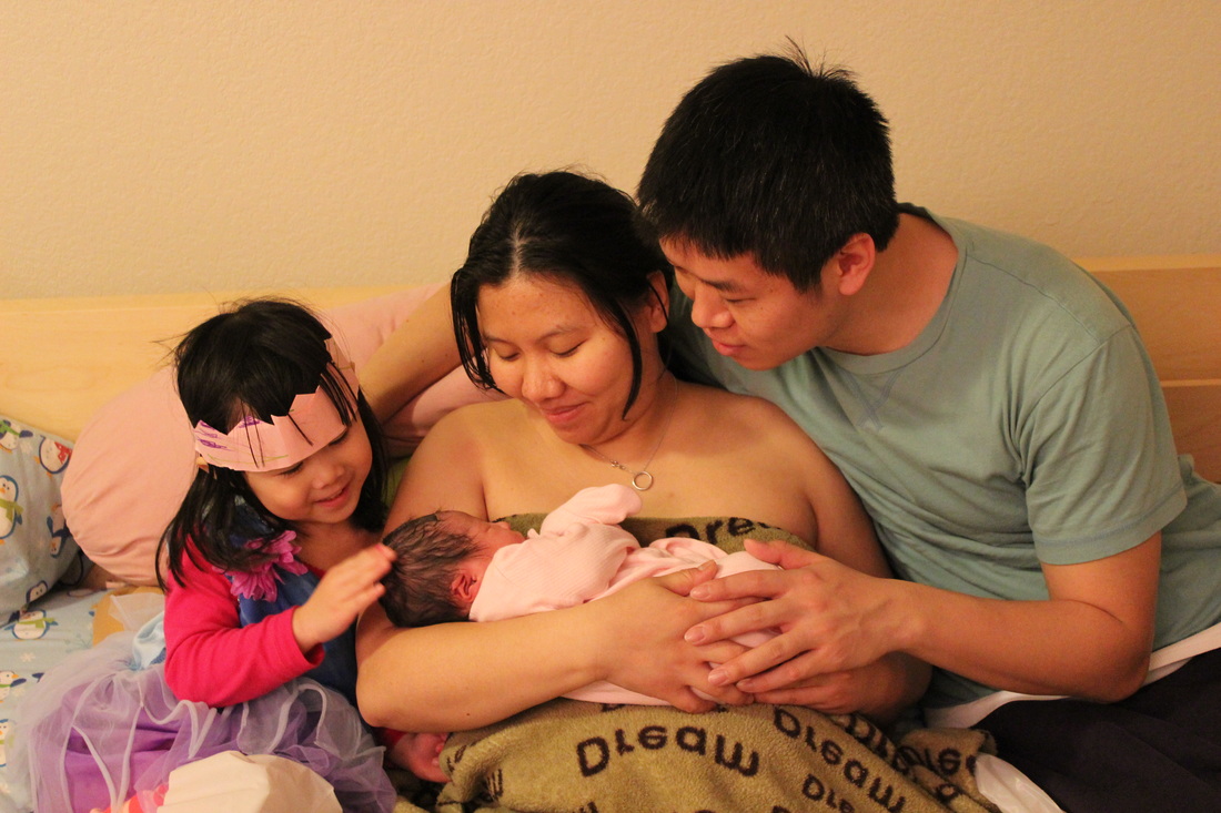 A family with their new baby after birth.