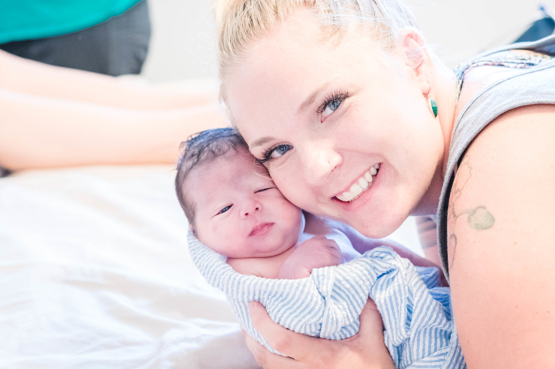 Tiffany Wilson, Puget Sound Doula, holding a baby